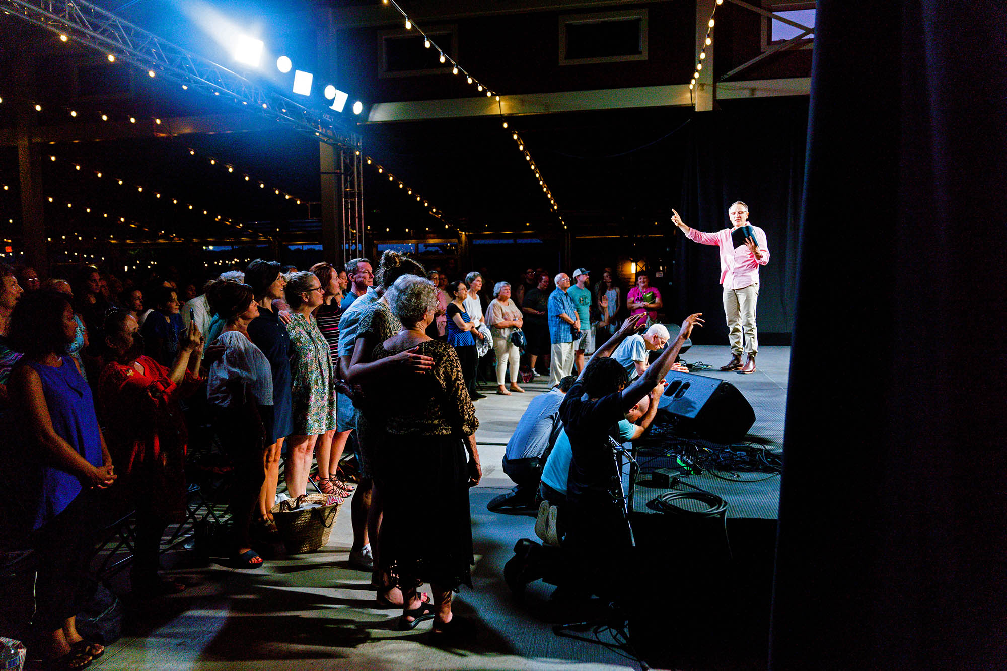 David giving a speech to a large crowd.